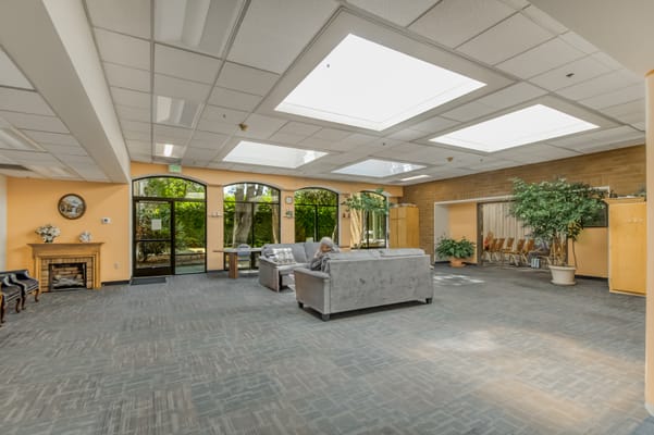 Bright common area with seating and natural light
