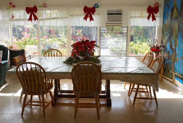 Bright dining room with a decorated table and views of greenery
