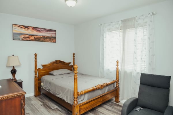 Cozy resident room with wooden bed and décor