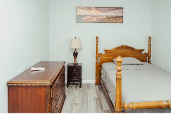 A well-furnished private resident room with wooden furniture