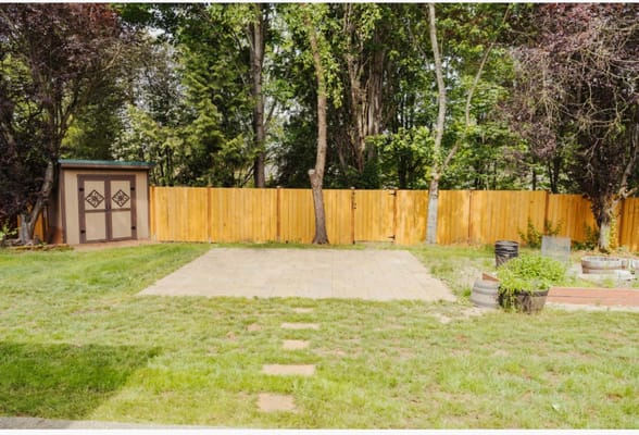 Quiet outdoor space with a fenced area and patio