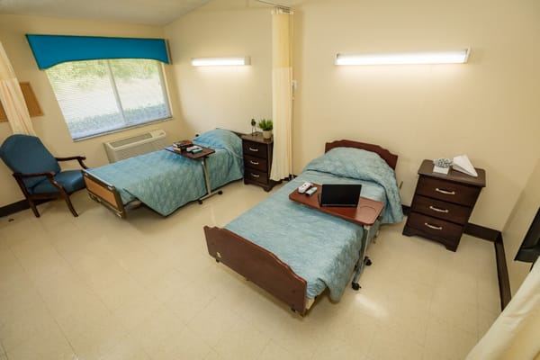 A view of a shared resident room with two beds and furniture