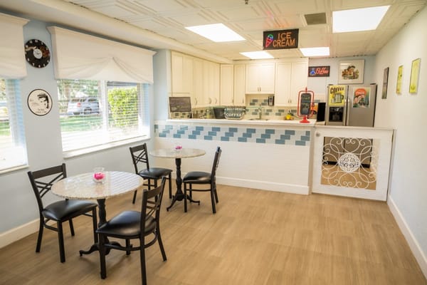 Bright dining area with tables and coffee bar
