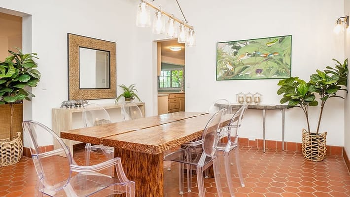 Modern dining room with a wooden table and transparent chairs