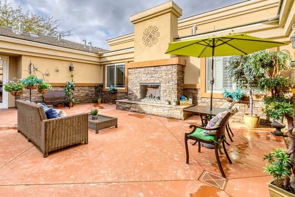 Outdoor patio area with seating and greenery