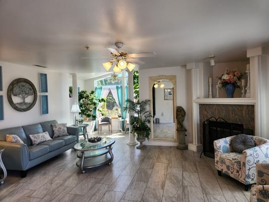 Bright common area with sofas and a fireplace