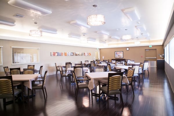 Bright dining room with tables set for meals