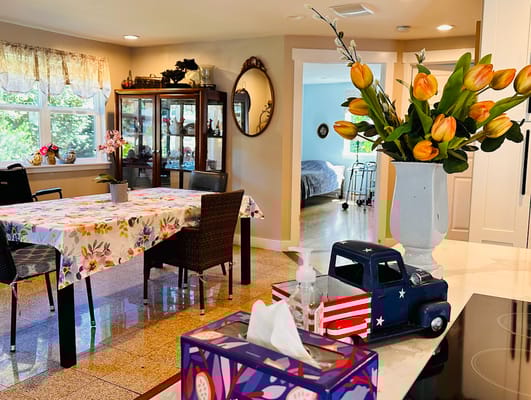 Bright dining area with colorful decor and flowers