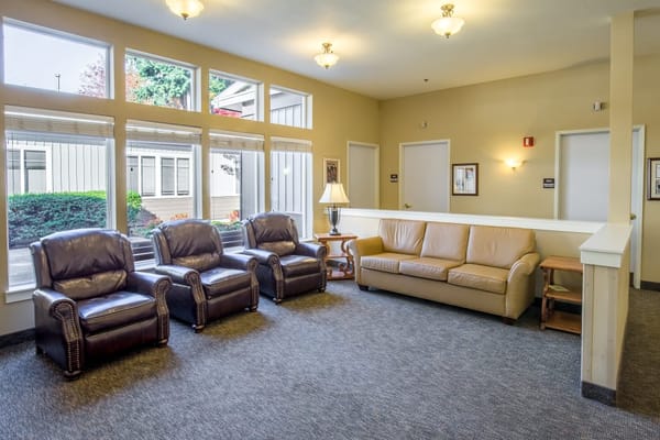 Living room with leather recliners and a sofa in Maple Grove Memory Care