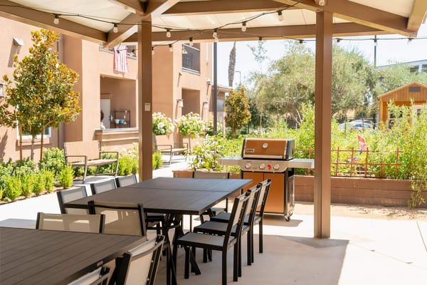 Outdoor patio area with seating and a grill