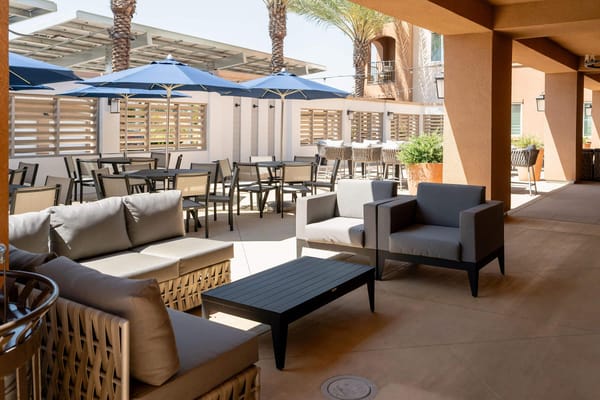 Outdoor seating area with umbrellas and furniture