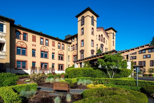 Exterior view of a senior living facility with gardens