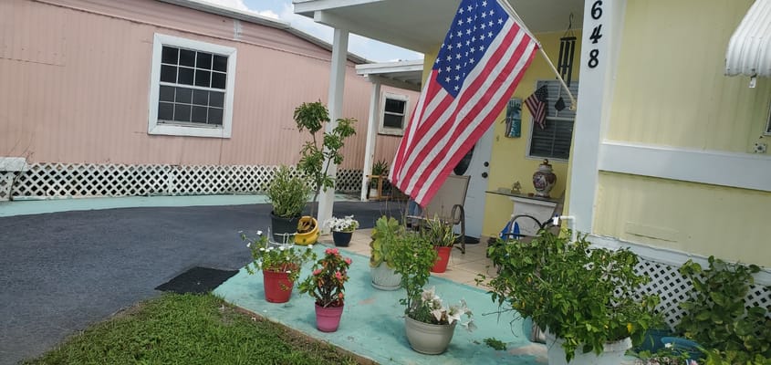Entrance with American flag and potted plants