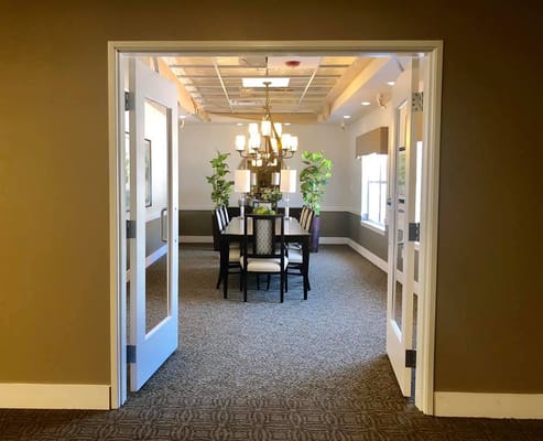 Brightly lit common area with dining setup