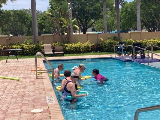 Residents participating in a water exercise class at the pool