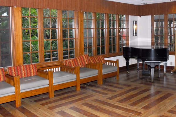 Interior view of a common area with a piano and seating