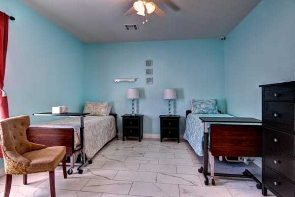 Two furnished resident rooms with beds and lamps