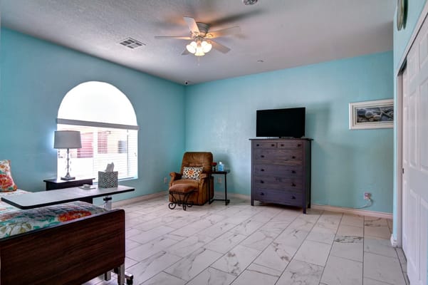 Brightly decorated resident room with blue walls