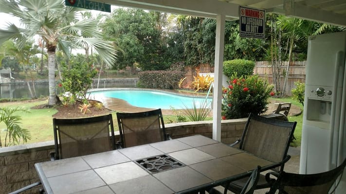 Outdoor space with pool and seating area