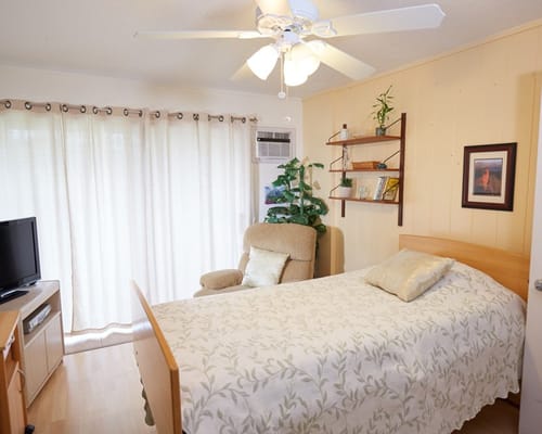 Cozy resident room with a bed and chair