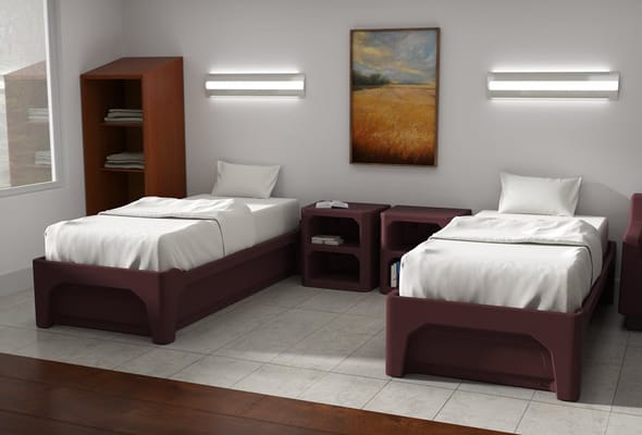 A shared bedroom with two twin beds, a bookshelf, and a nightstand.