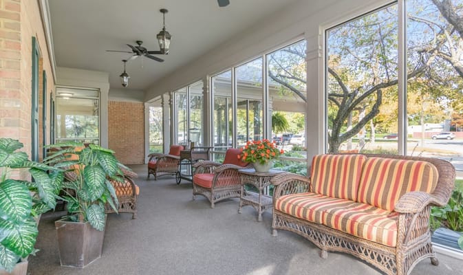 Covered porch with wicker chairs and plants