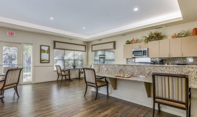 Bright common area with seating and kitchenette