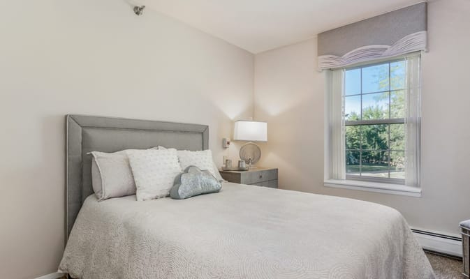 Cozy interior of a resident room with a bed and window