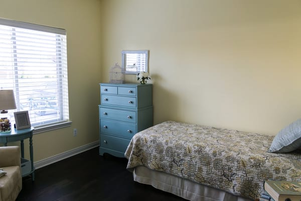 Cozy, well-furnished resident room with natural light