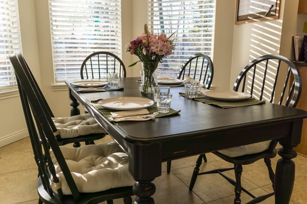 Dining table set with flowers and place settings