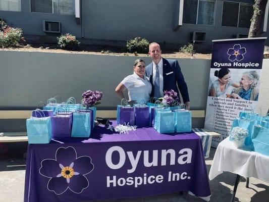 Staff members at a table with gift bags for an event