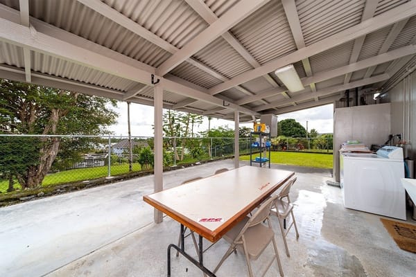 Outdoor covered space with a table and chairs