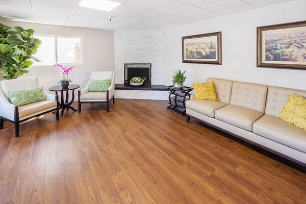 A cozy interior common area with seating and plants