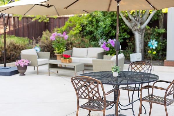 Outdoor seating area with tables and flowers