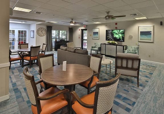 Common area with seating and a TV in the facility