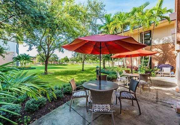 Outdoor seating area with umbrellas and lush greenery