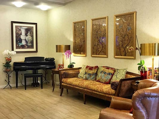 Common area with a sofa, piano, and artwork