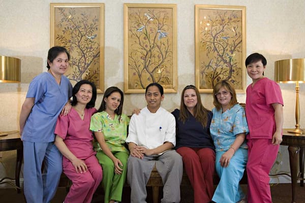 Care staff posing together in a facility lobby