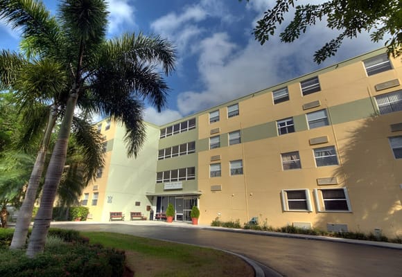 View of the Puerta Del Sol building with palm trees