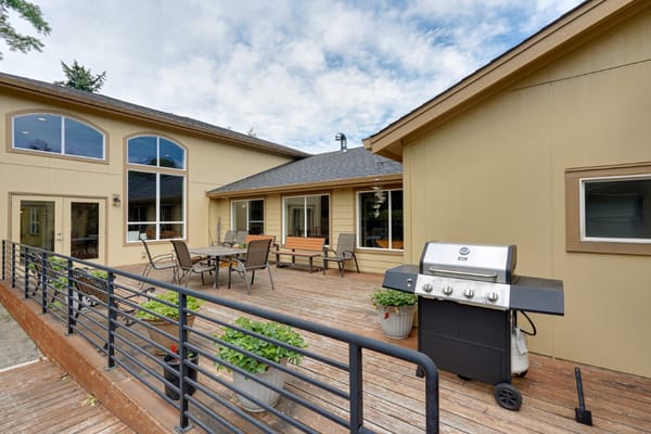 Outdoor patio area with a grill and seating