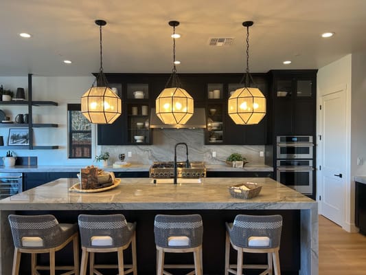 Contemporary kitchen with marble countertop and pendant lights
