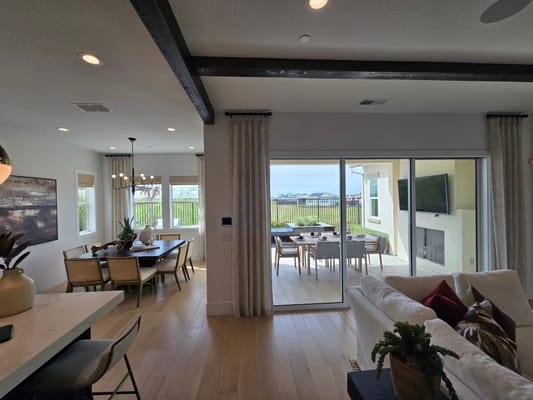 Bright living area featuring a dining table and patio access.