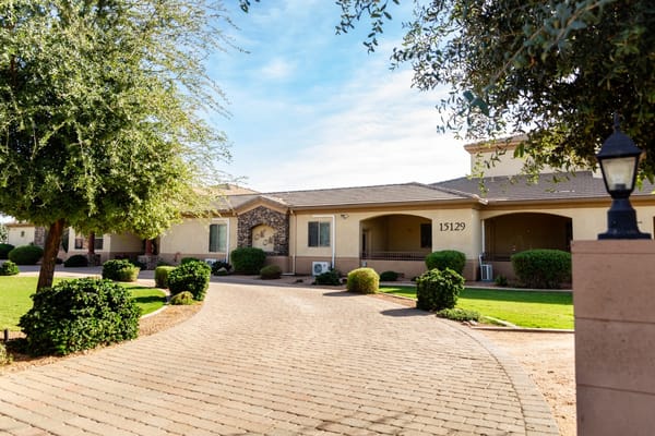Front view of Renaissance Senior Living facility with landscaped pathway