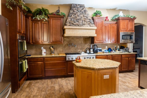 Well-equipped kitchen with granite countertops and wooden cabinets