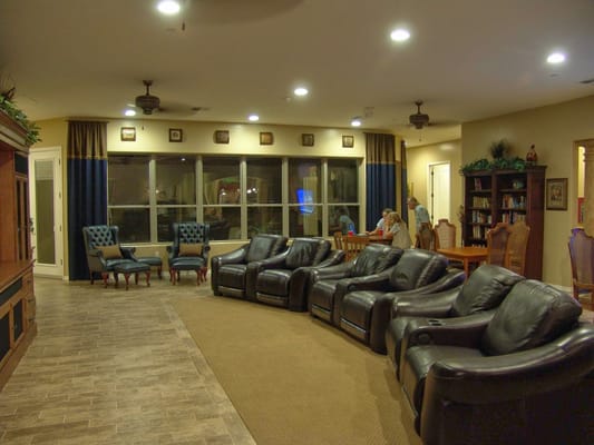 Cozy lounge area with leather seating and shelves of books