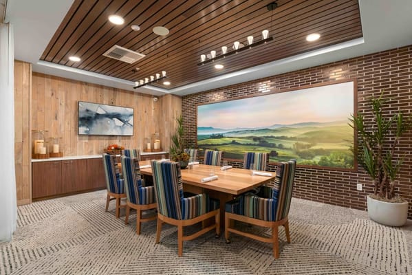 Bright dining room with wooden table and striped chairs