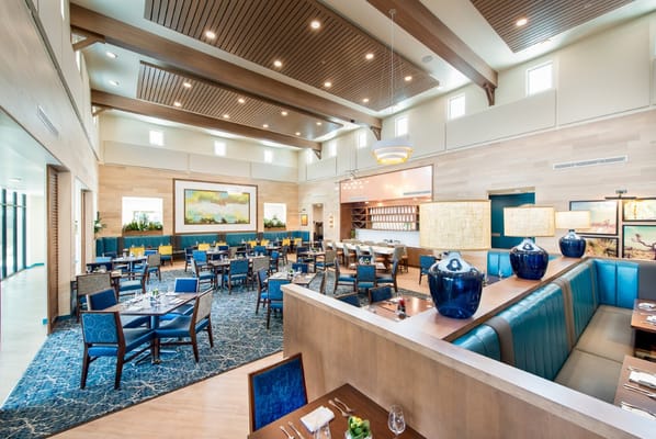 Bright dining area with tables and blue accents