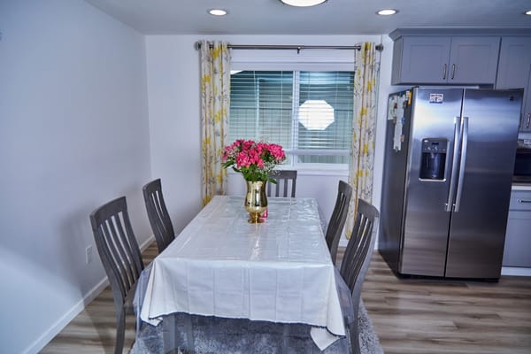 Bright dining area with a table and flowers