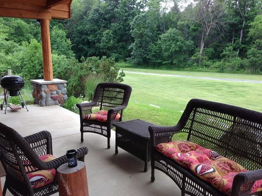 Outdoor seating area with chairs and greenery