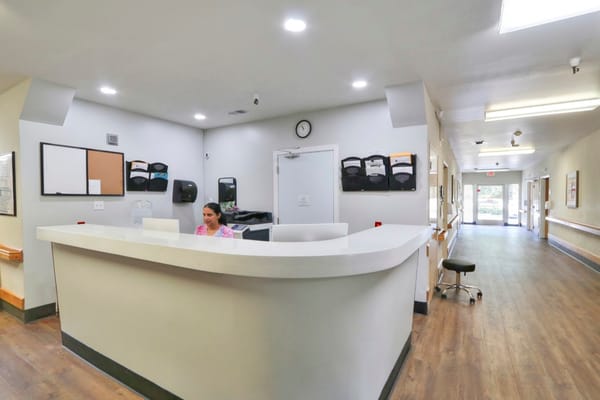 Reception area with staff member and front desk